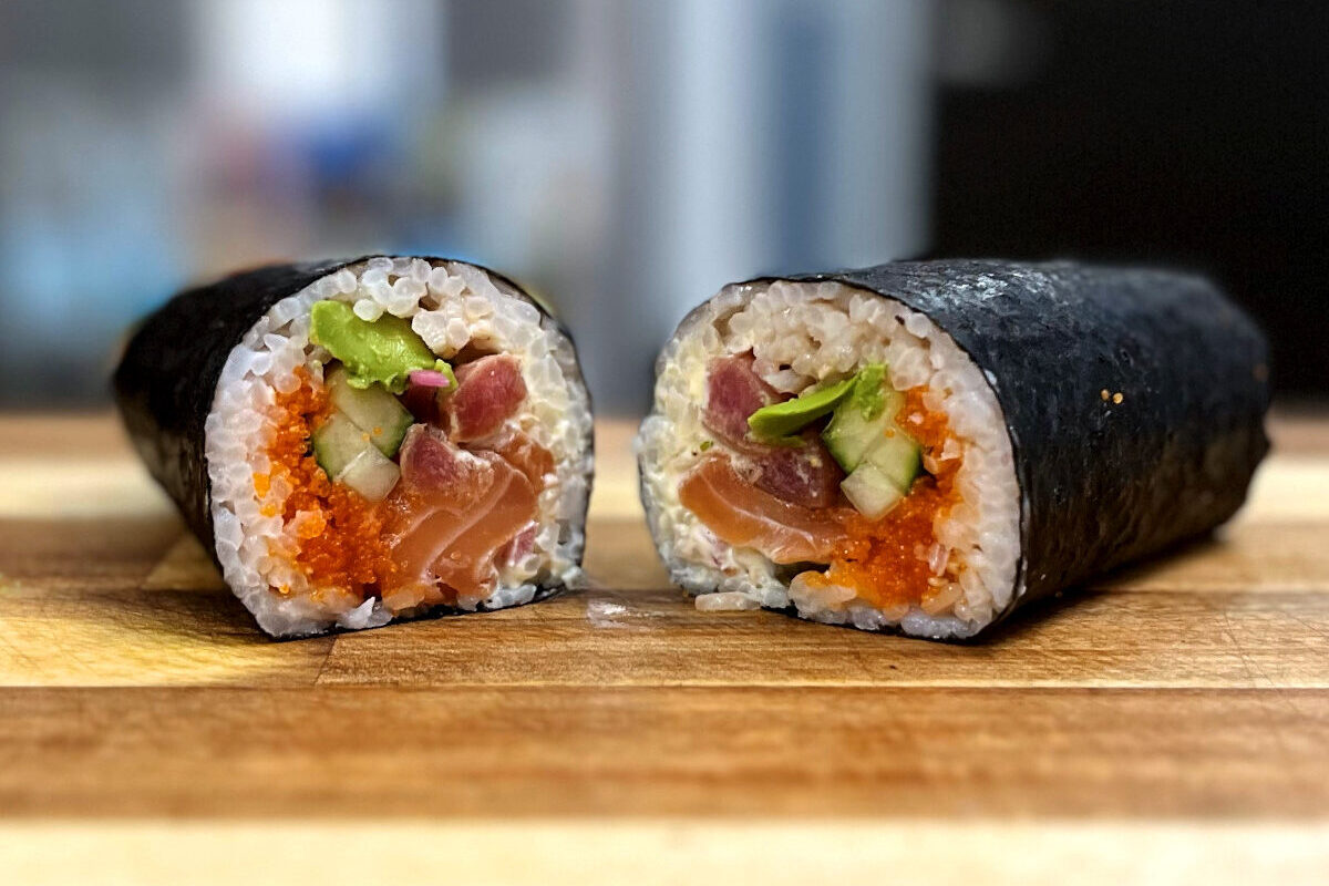 side view of a rolled sushi burrito split into half