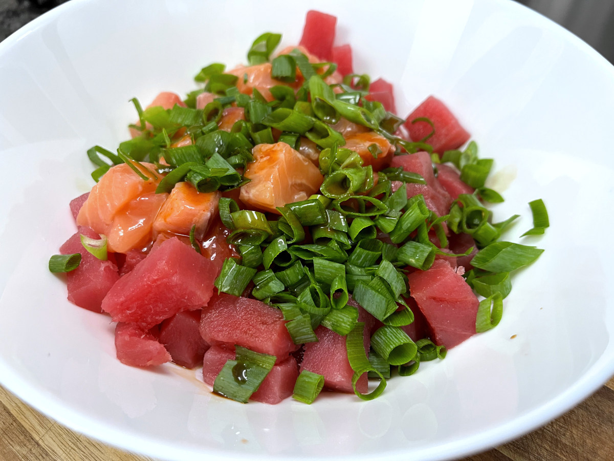 chopped green onions, salmon and tuna mixed in a bowl