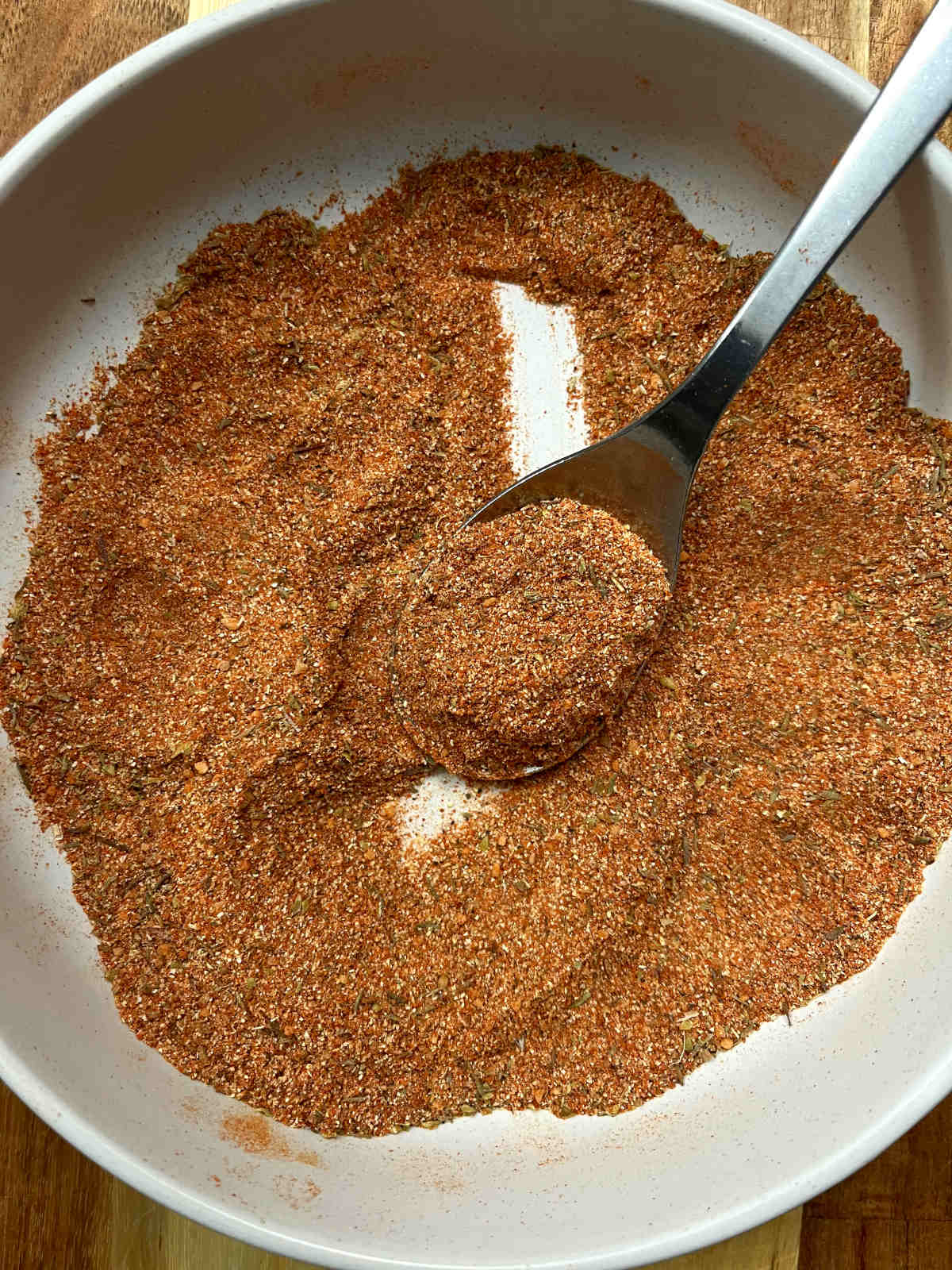 A spoon of cajun mix from the blended spice bowl