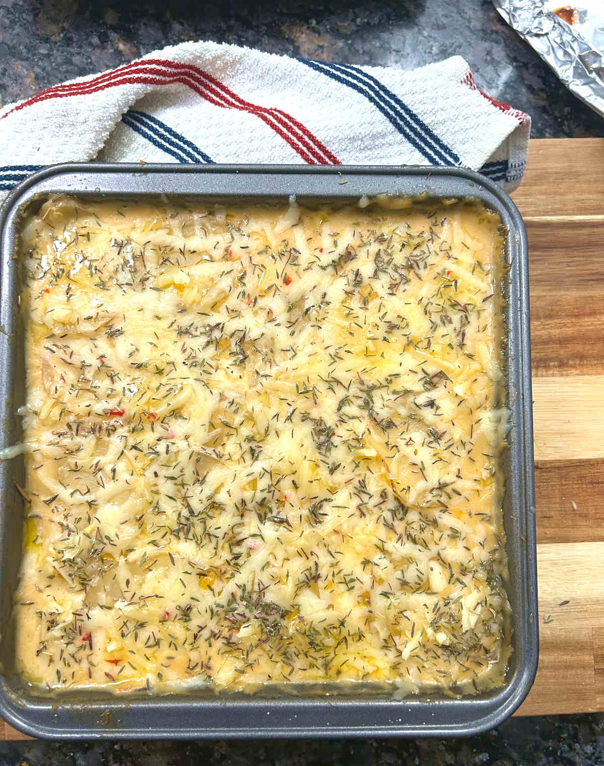 baking dish layered with cheese and thyme