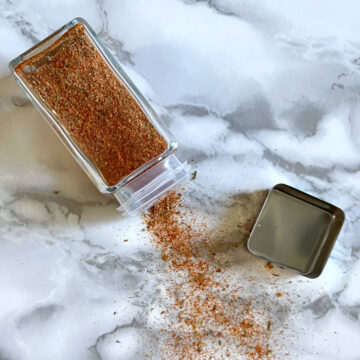 Cajun seasoning pouring out of a jar