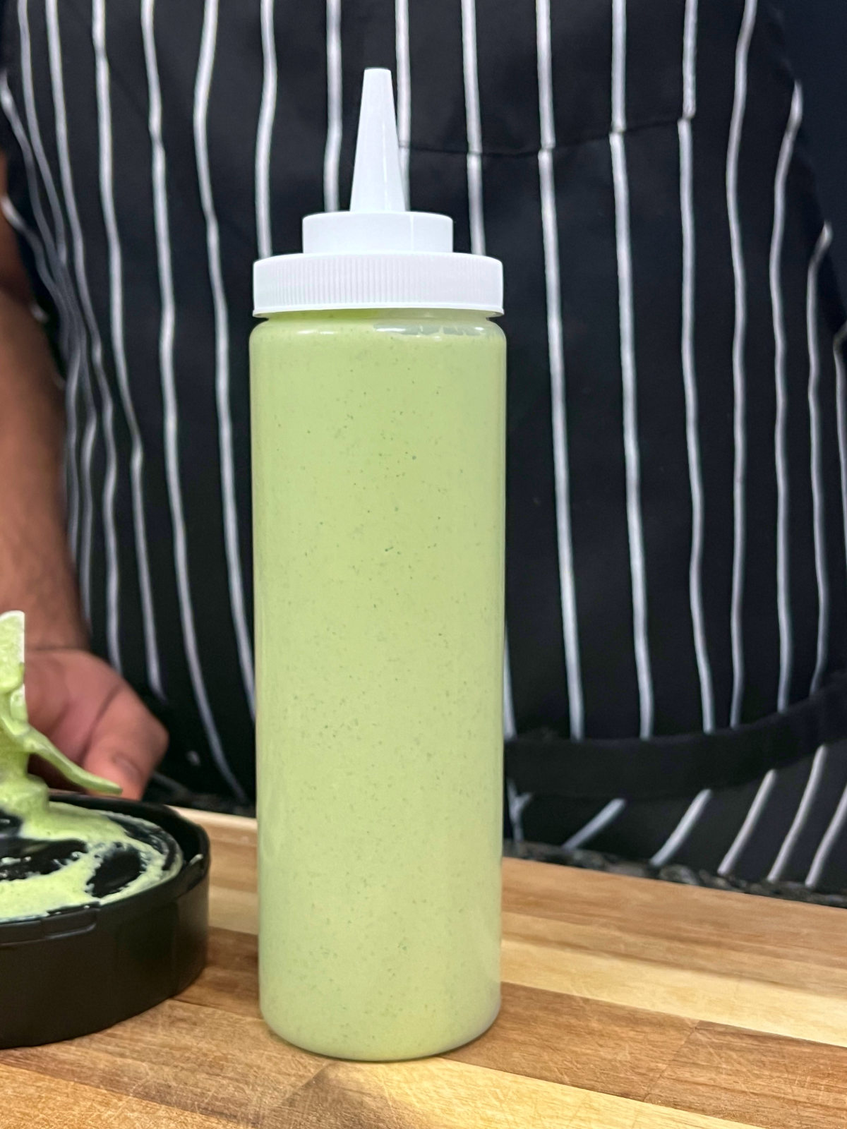 Aji Verde sauce in a squeeze bottle