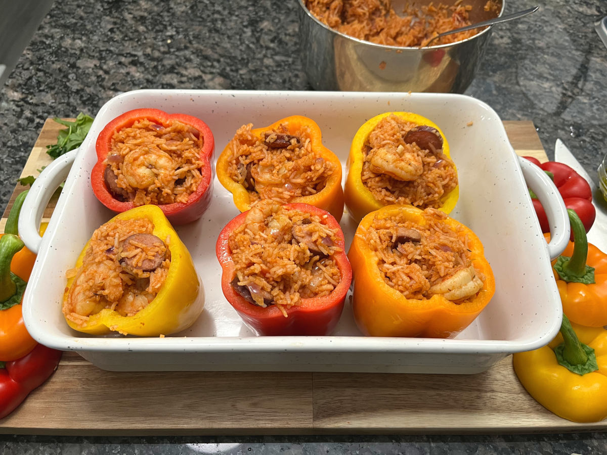 bell peppers stuffed with rice in a baking dish