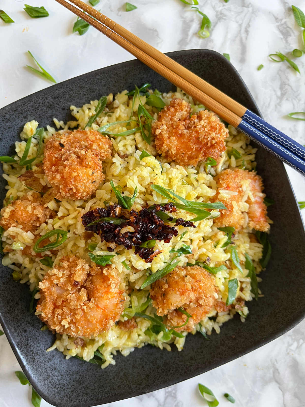 Shrimp fried rice in a bowl with chopsticks on the side