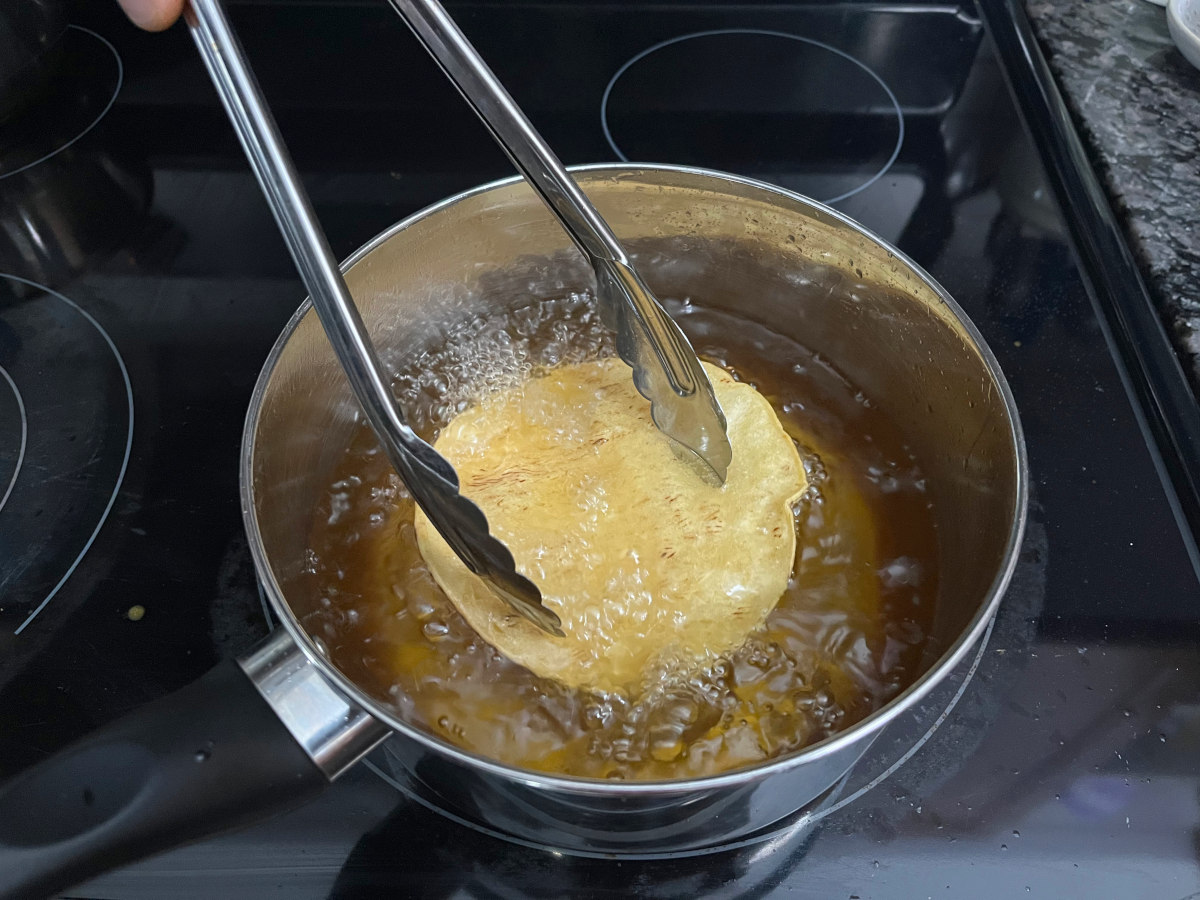 Deep frying a tortilla in a pan