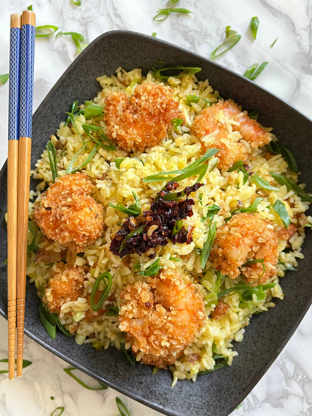 Shrimp fried rice in a bowl with chopsticks on the side
