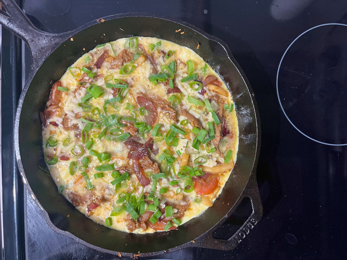 green onions added to the omelet in the skillet