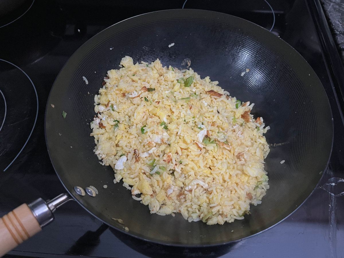 Mixed golden fried rice with ingredients in the wok