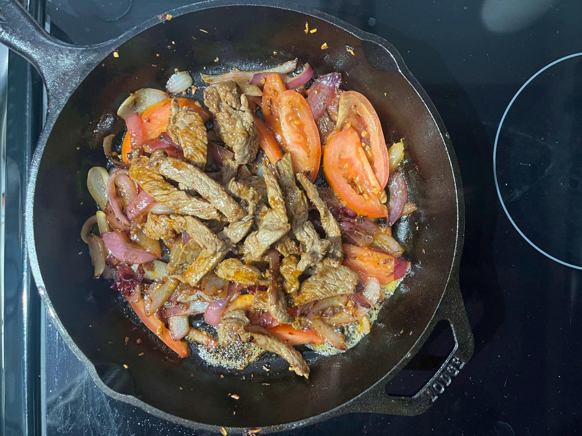 beef, garlic, onions and tomatoes in a skillet