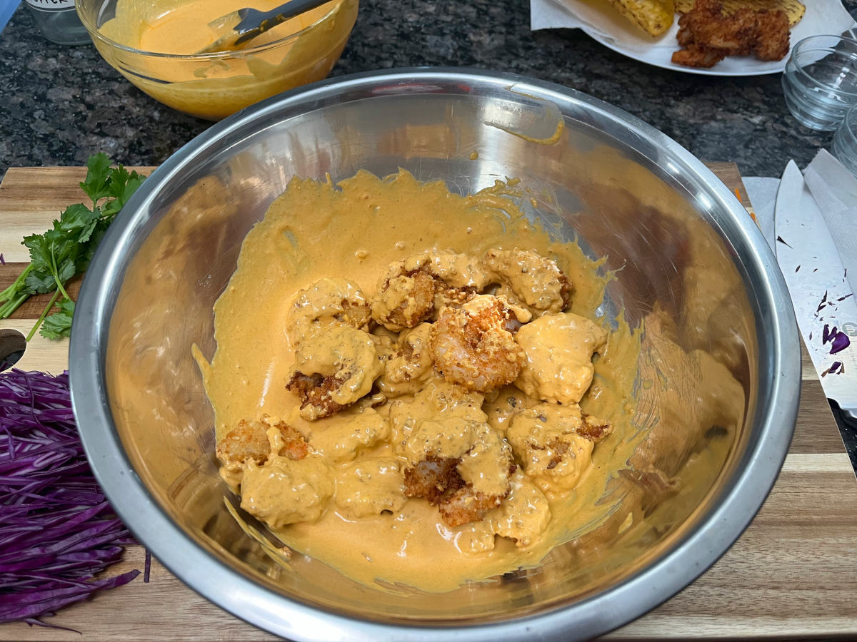 Tossing the prawns and Thai curry sauce in a bowl