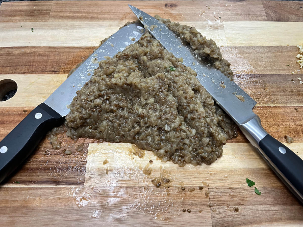 Chopped eggplants with knives on the cutting board