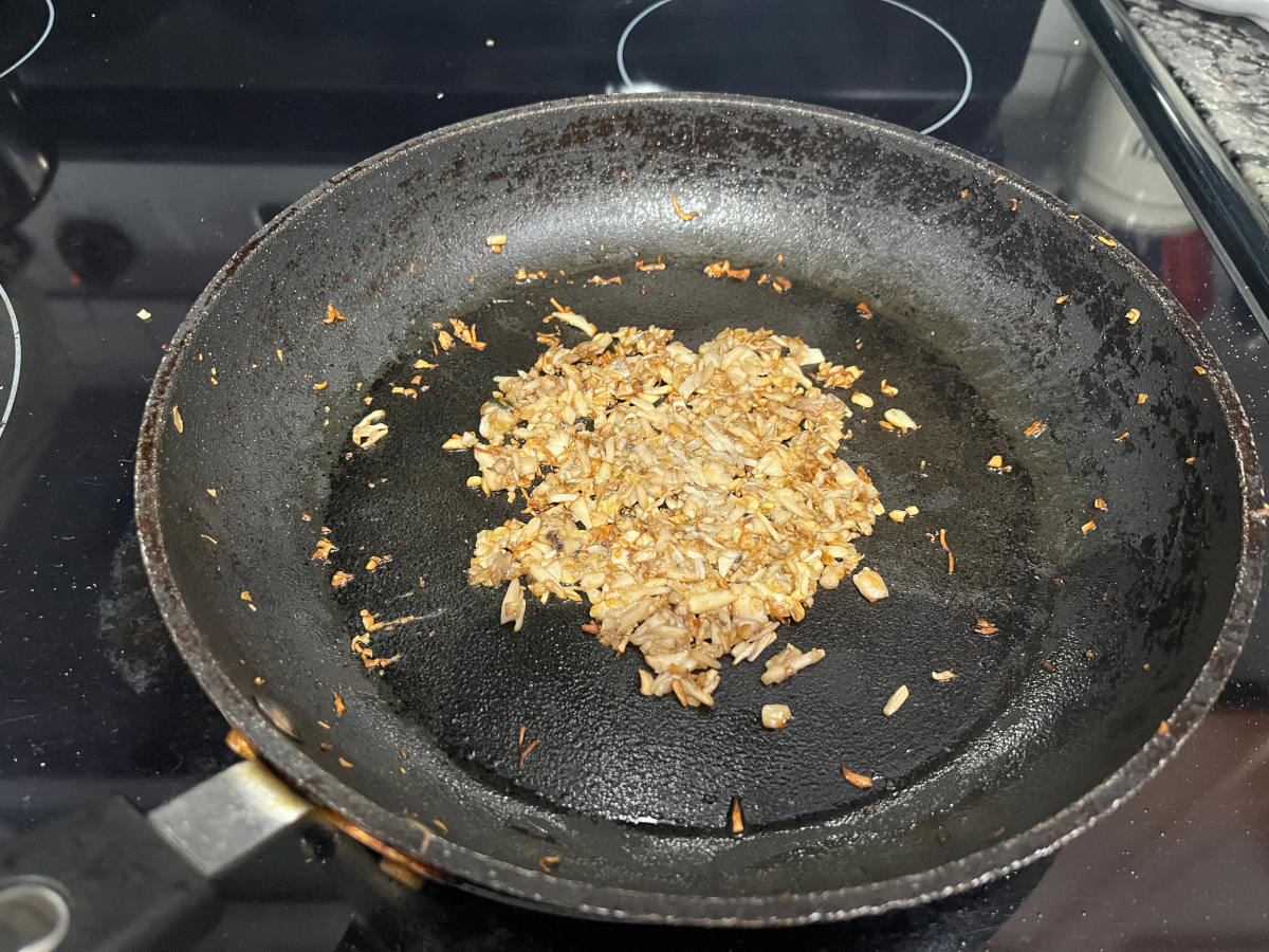sautéed garlic and chopped mushroom stems in a pan