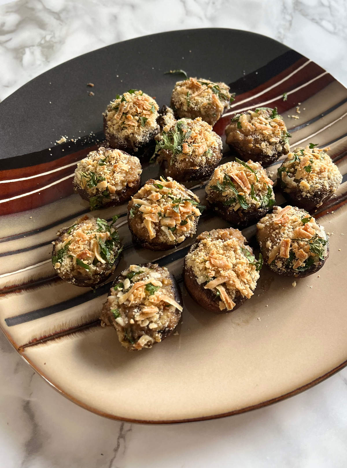 12 baba ganoush stuffed mushrooms on a plate
