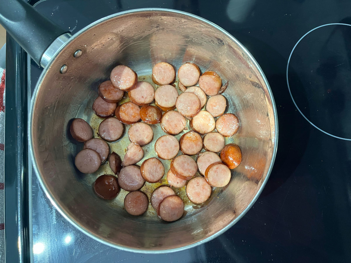 sliced smoked sausages in a pot