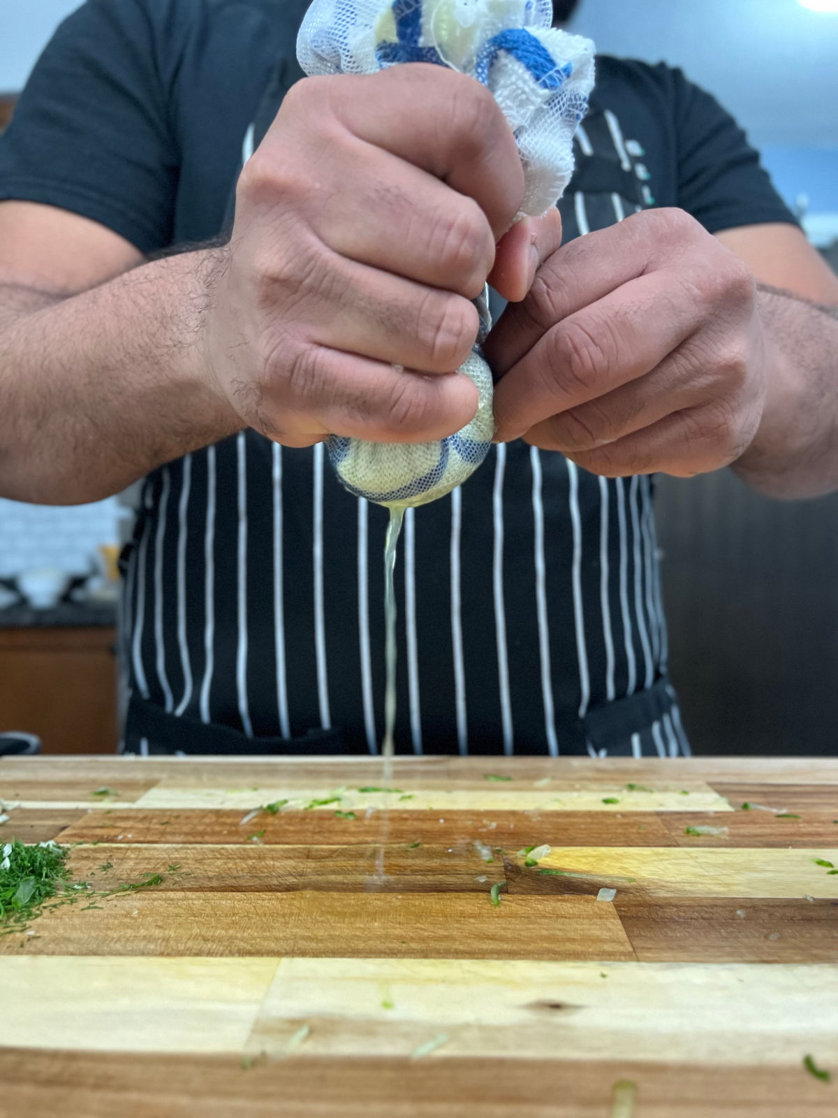 Grated cucumber squeezed in a cloth is leaving all water.
