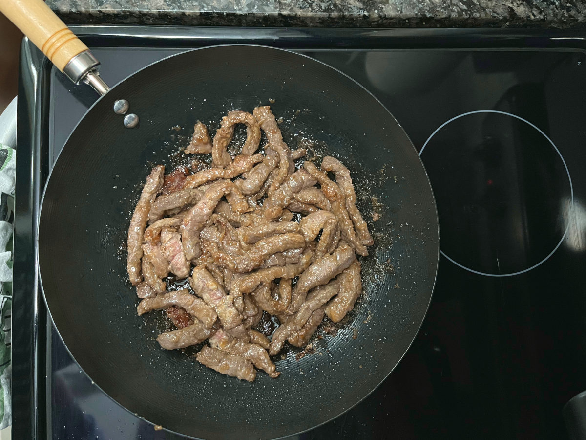 beef frying in a wok