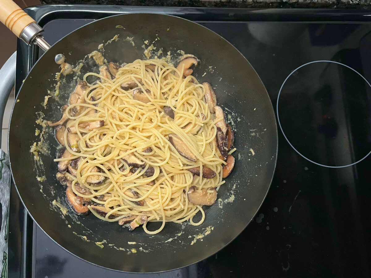 cooked spaghetti added to the wok with the miso mushrooms