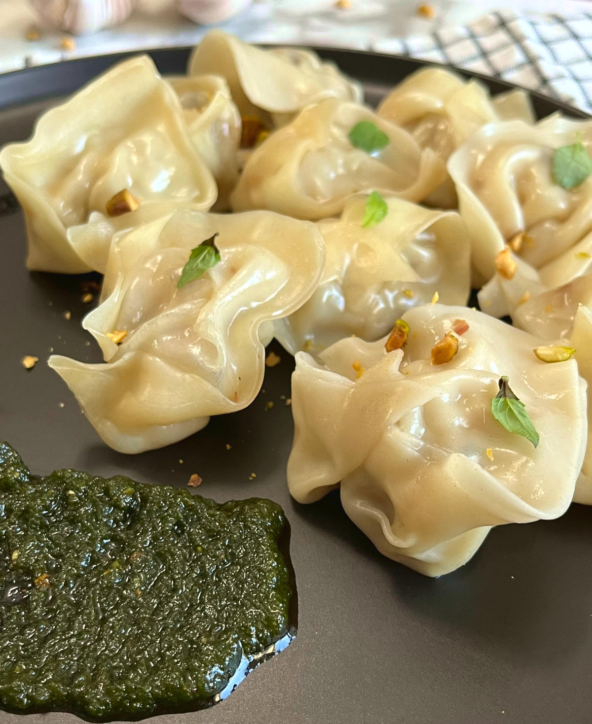 Shrimp wonton in a plate with pesto sauce