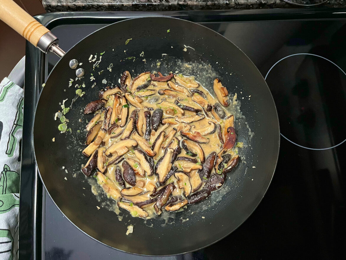 miso mixture added to the wok with mushrooms and other ingredients