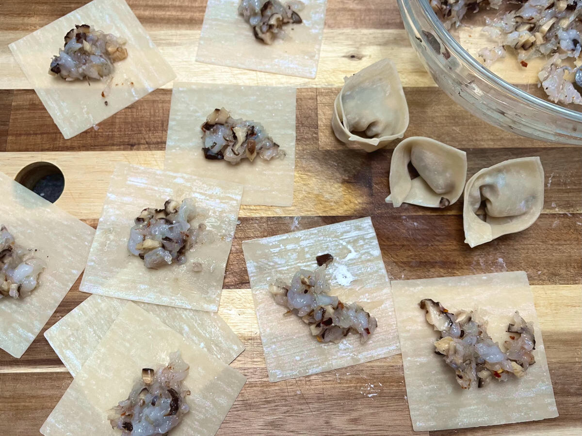 shrimp filling on multiple wrappers and three folded wontons