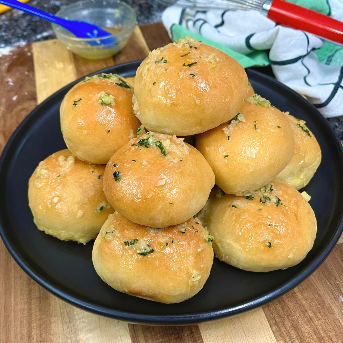 Garlic butter cheese buns piled on a plate
