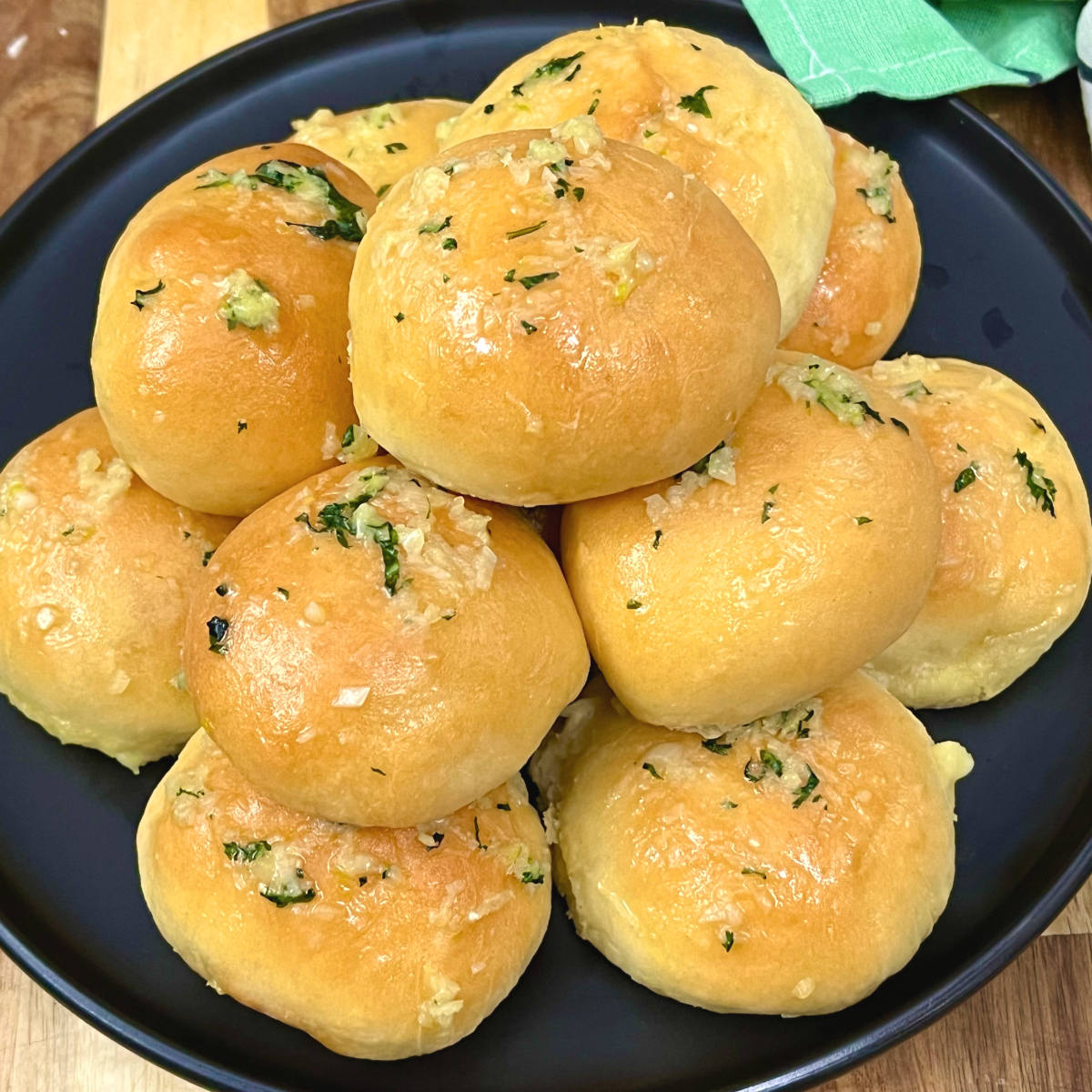 Garlic butter cheese buns piled on a plate