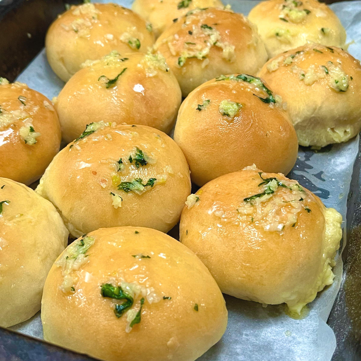 Garlic butter cheese buns in a baking tray