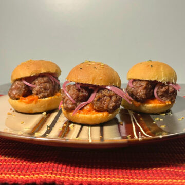 three cevapi sliders on a plate
