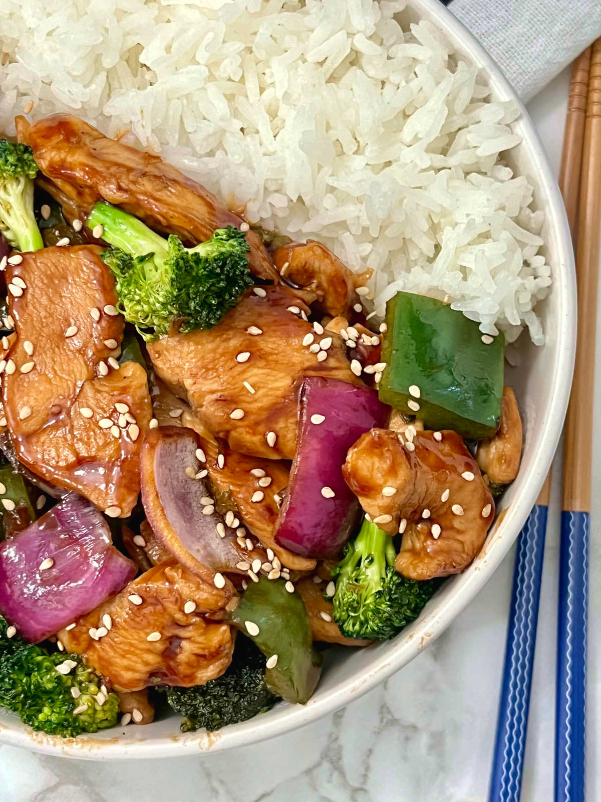 hoisin chicken and broccoli stir-fry with chopsticks on the side