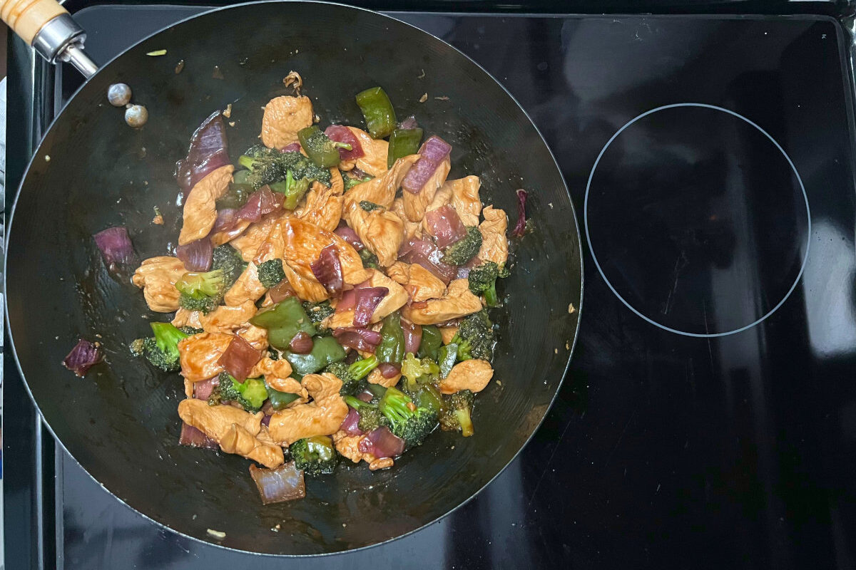 hoisin chicken and veggies stir fry in a wok