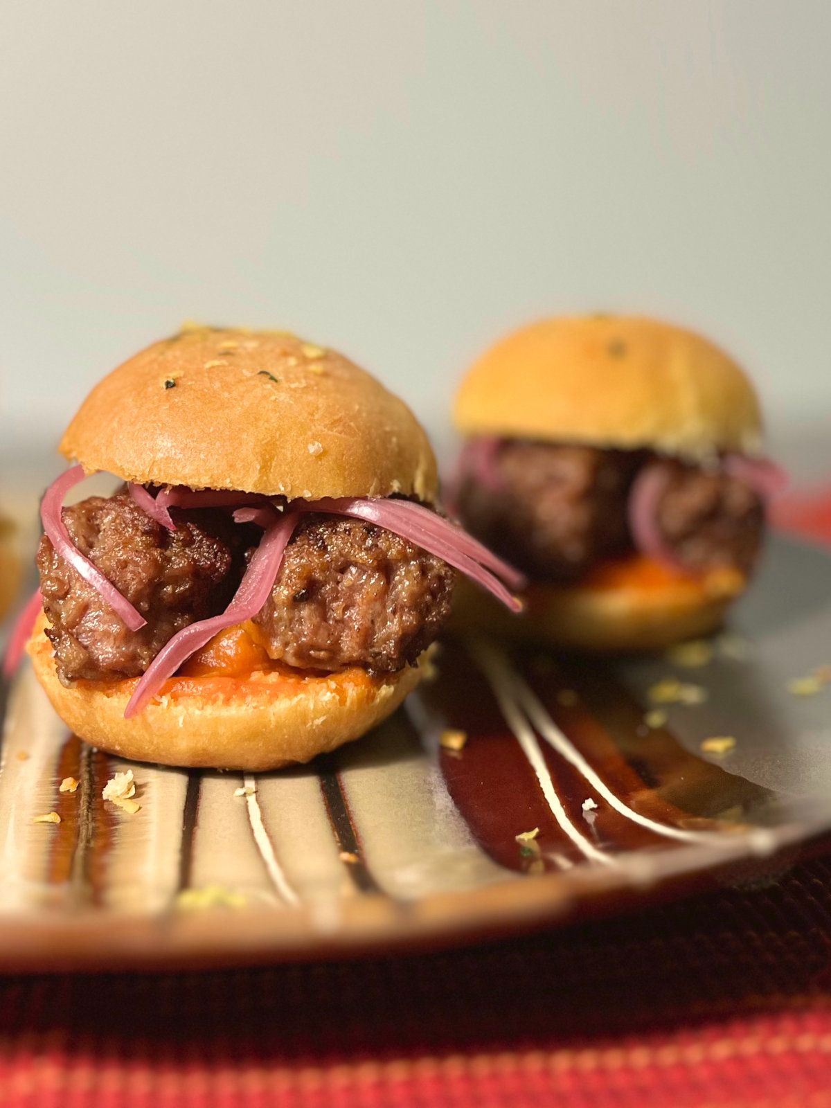 two cevapi sliders on a plate