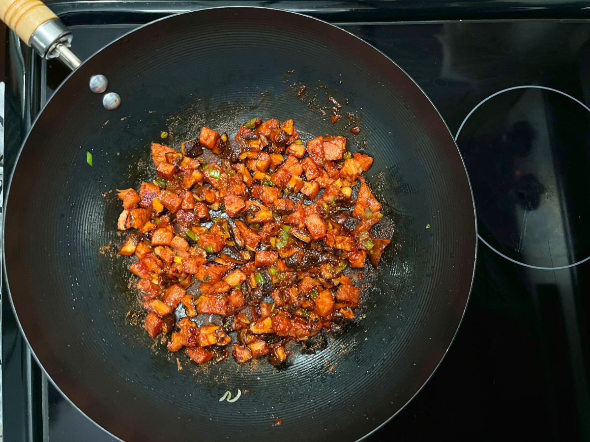 ingredients with gochujang frying in a wok