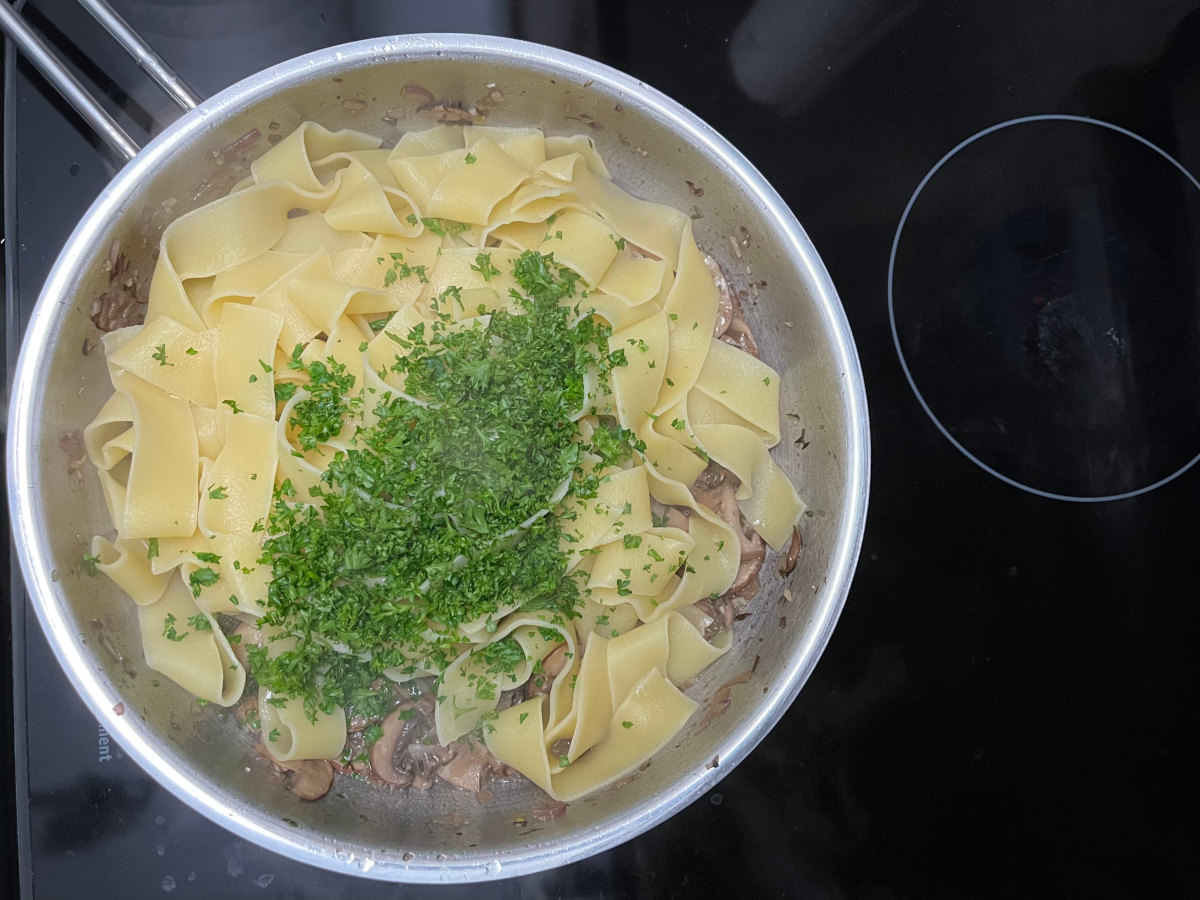 pappardelle with chopped parsley in a pan