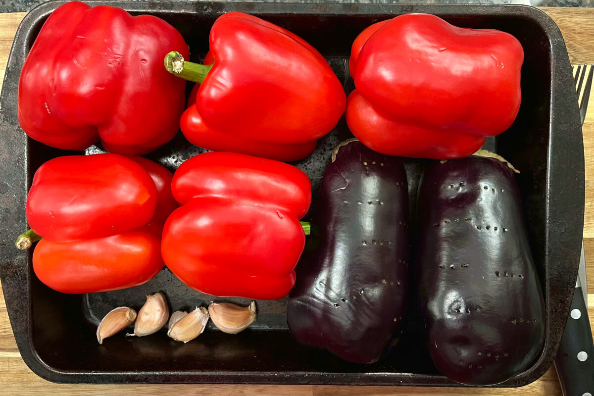 bell peppers, eggplant and garlic in a baking tray