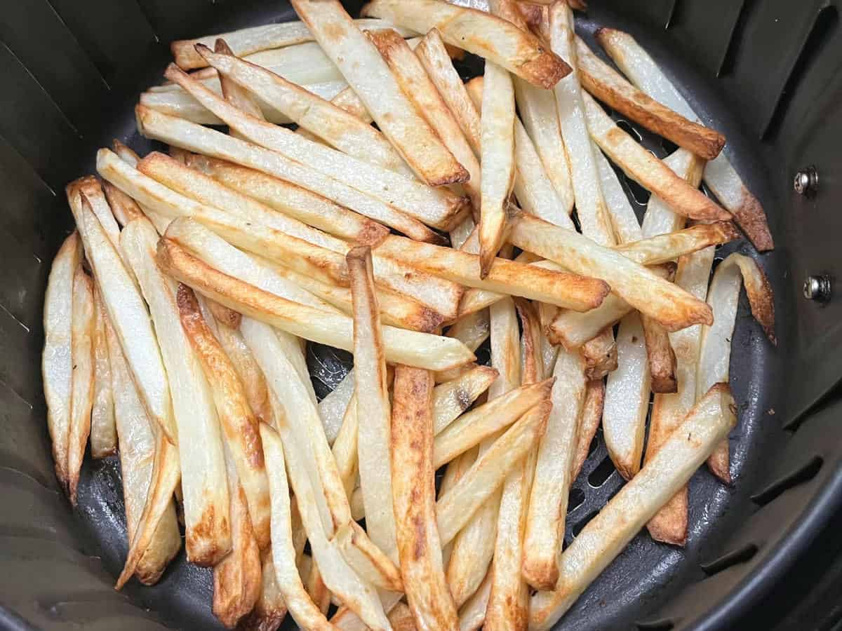 cooked potatoes in an air fryer basket