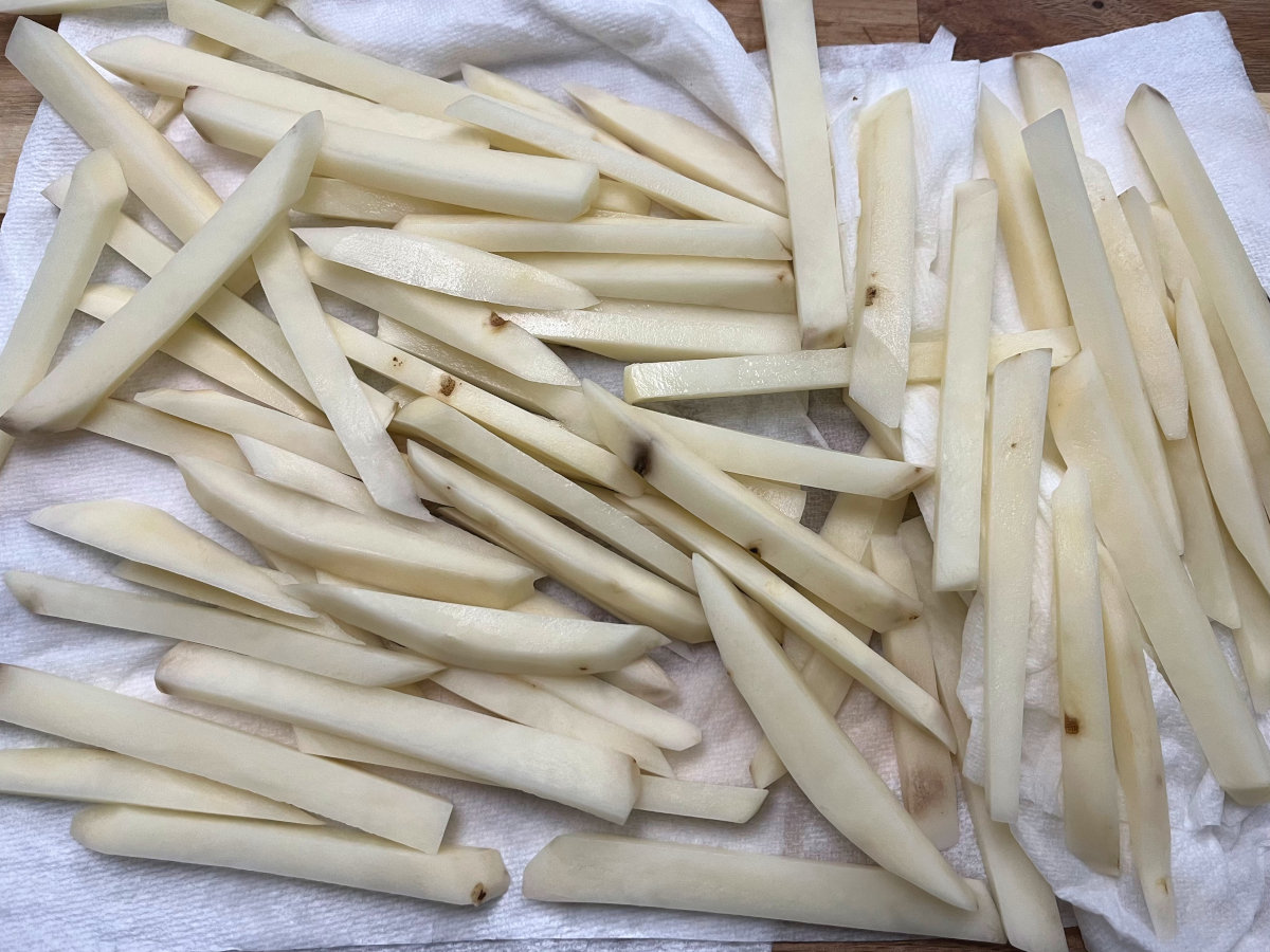 cut potatoes drying on a paper towel