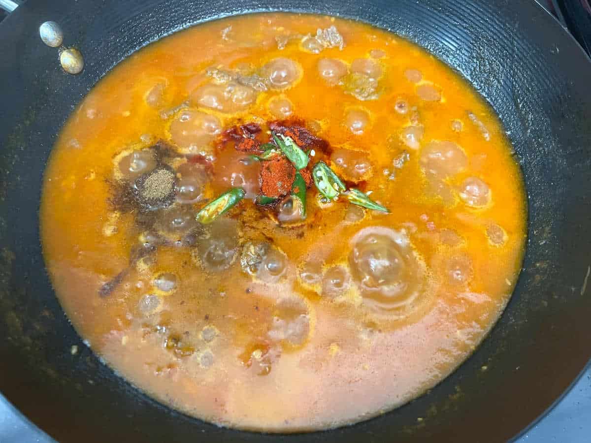 karahi sauce simmering in a pan
