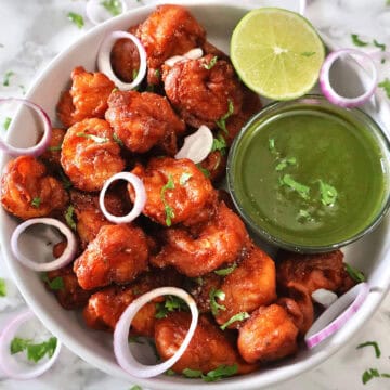 Prawn Koliwada with green chutney and lime wedge