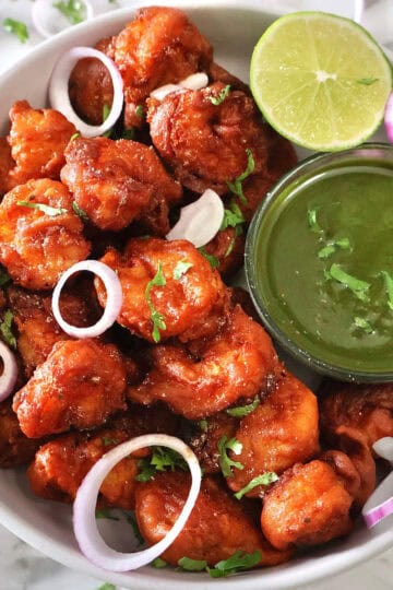 Prawn Koliwada with green chutney and lime wedge