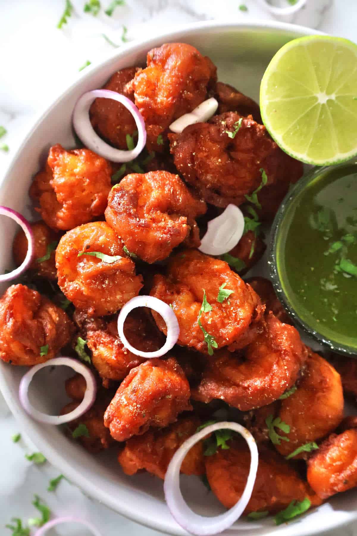 Prawn Koliwada with green chutney and lime wedge